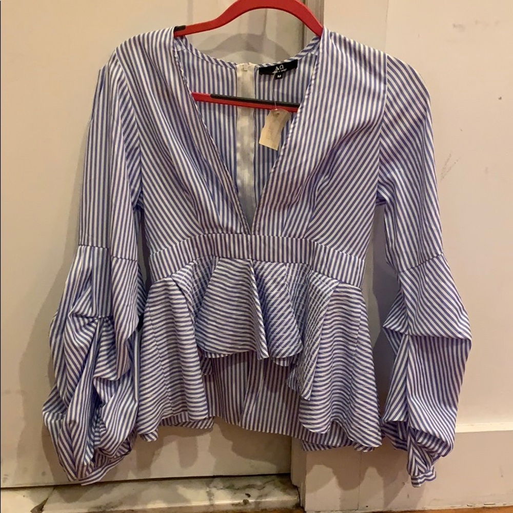 Never worn- blouse (high-low) in the front.